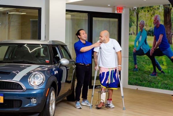 Staff assisting a resident near a vehicle