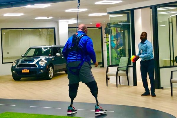 Therapist assisting patient in an indoor therapy area
