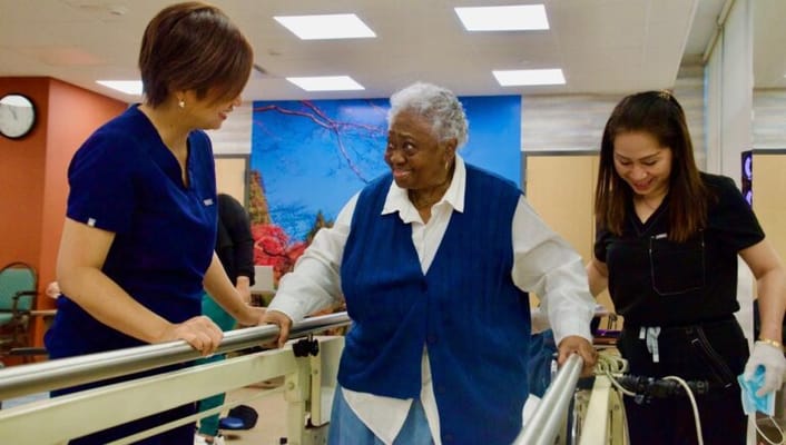 Residents engaging with staff in an activity room
