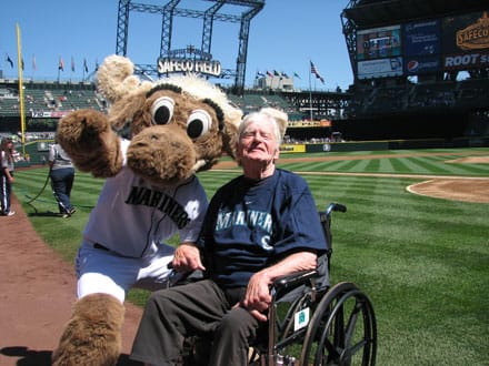Resident enjoying a baseball game with a mascot