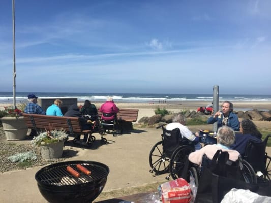 Residents enjoying a barbecue on a seaside patio