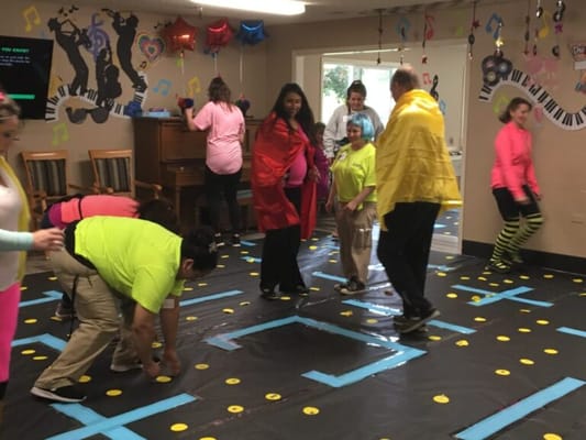 Residents and staff participating in an indoor activity