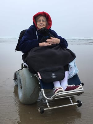 Resident enjoying the beach in a wheelchair
