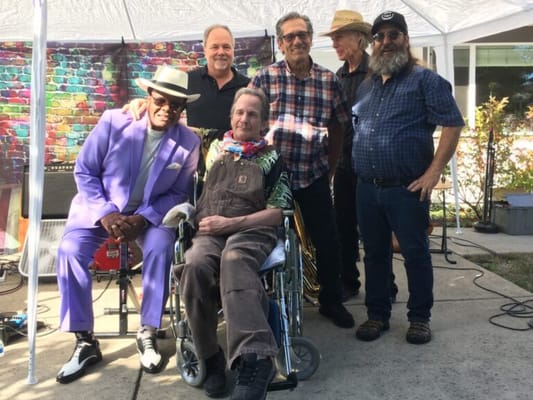 Residents and staff enjoying a music event outdoors