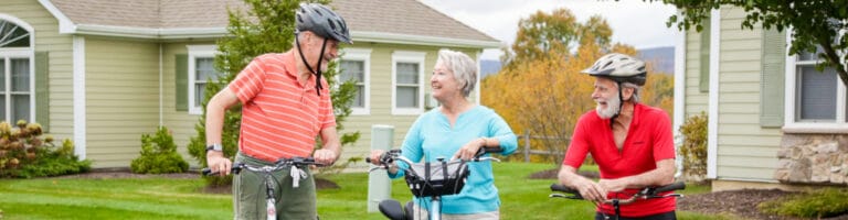 Residents chatting while riding bicycles in a garden