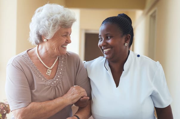 Resident and staff member interacting happily