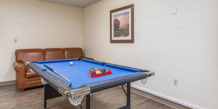 Game room with a pool table and couch