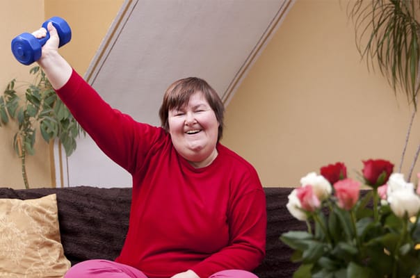 Resident exercising with dumbbell in a cozy living space