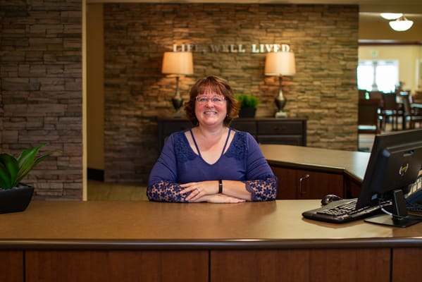 Reception area with a staff member greeting visitors