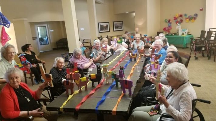 Residents participating in a craft activity around a table