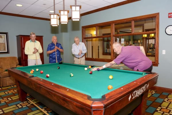 Residents playing billiards in a common area