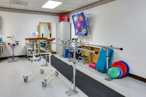 Rehabilitation room with exercise equipment and mats