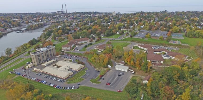 Aerial view of a senior living facility with gardens