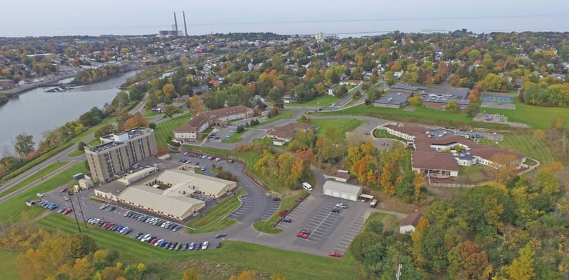 Aerial view of a senior living facility with gardens