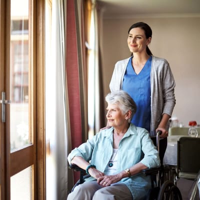 Caregiver assisting a resident in a bright room