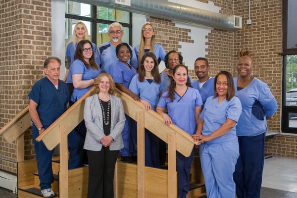 Staff members posing together in a common area