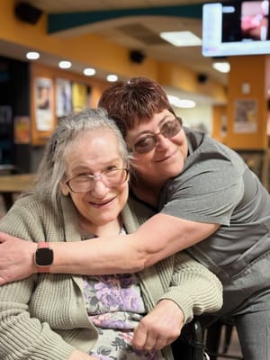 Two residents smiling and enjoying time together