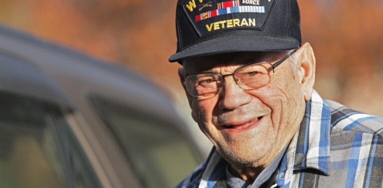 Smiling elderly veteran wearing a cap
