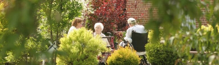 Residents enjoying time in a lush outdoor space