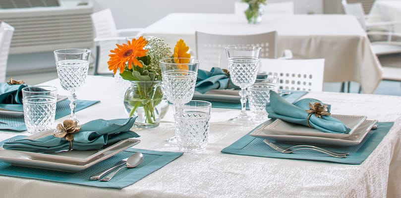 Elegant dining table set with flowers and glassware