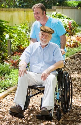 A caregiver assisting a senior in a vibrant garden