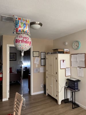 Birthday balloons in a cozy facility room