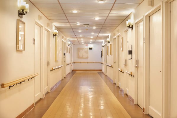 Interior hallway with resident rooms and soft lighting