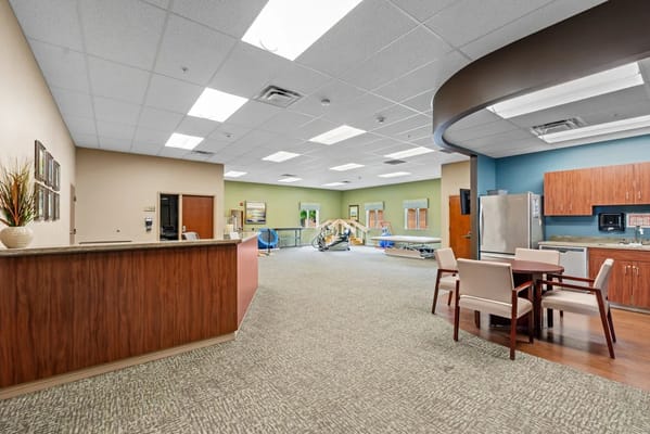 Bright common area with seating and kitchen