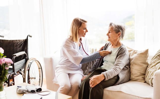 Caregiver checking a resident's heartbeat in a cozy setting