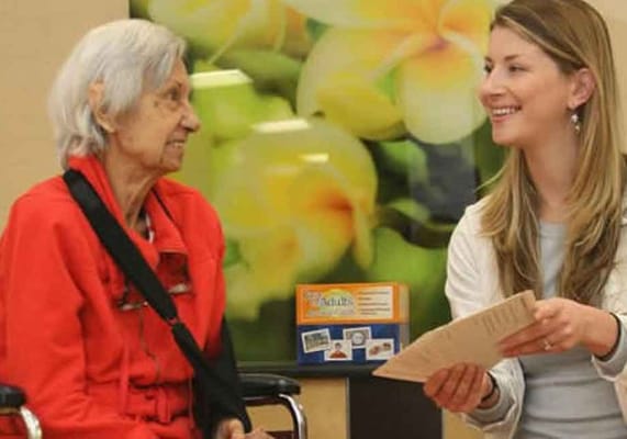A caregiver and resident interacting in a comfortable setting