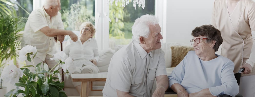 Residents enjoying conversation in a bright common area