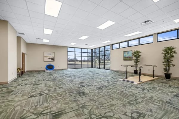 Bright activity room with large windows and open space