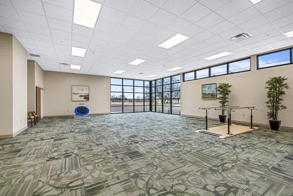Bright activity room with large windows and open space