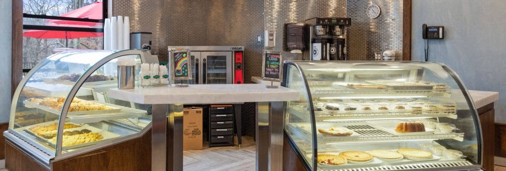 Café display with a variety of pastries and desserts