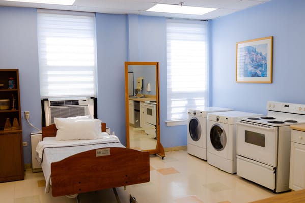 Bright interior of a resident room with laundry facilities