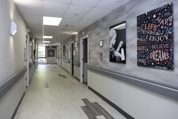 Bright hallway in a senior living facility with artwork
