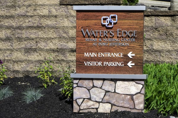 Sign for Water's Edge Nursing Center with directions