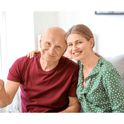 An elderly man and a young woman smiling together
