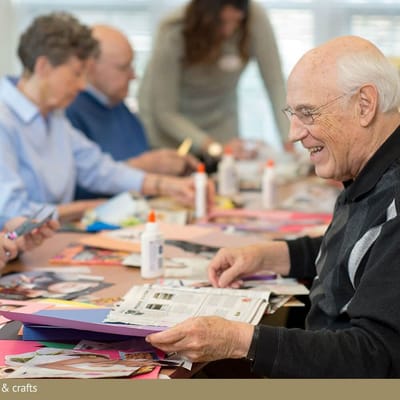 Residents engaged in a crafting activity at a table