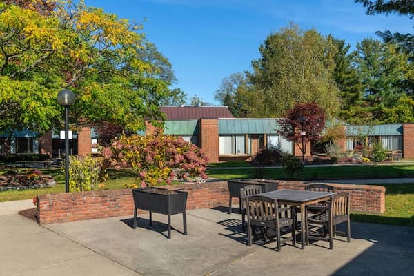 Outdoor space with tables surrounded by gardens