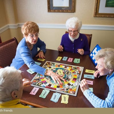 Residents playing a board game in a common area