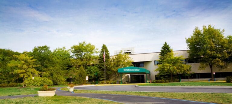 Exterior view of a senior living facility with landscaped gardens
