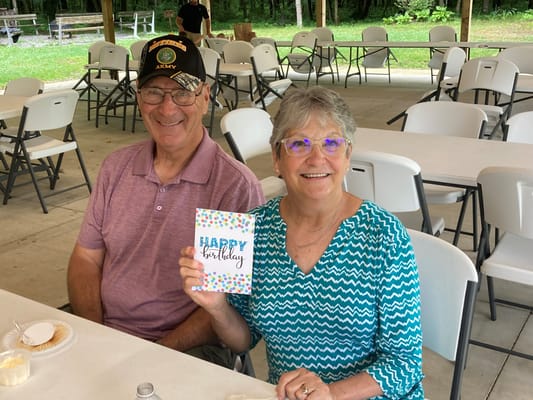 Residents celebrating a birthday outdoors at a picnic