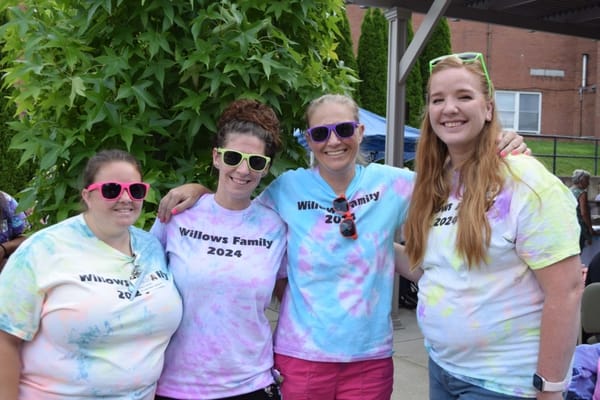 Staff members wearing colorful shirts at a celebration