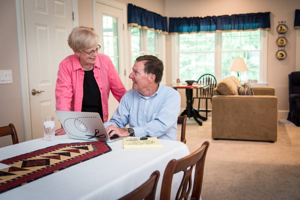 Residents engaged in conversation in a cozy living area