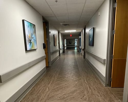 Bright hallway with artwork in a senior care facility