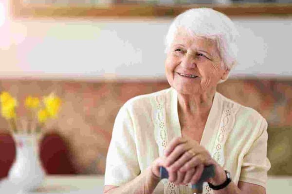 Smiling elderly woman in a facility interior