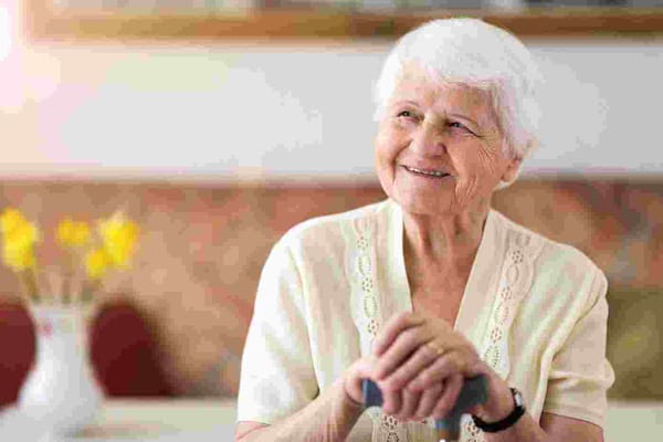 Smiling elderly woman in a facility interior