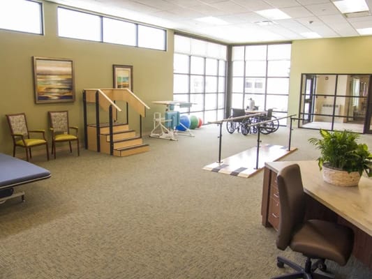 Physical therapy area with equipment and seating