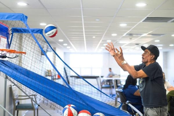 Resident playing basketball in a common area